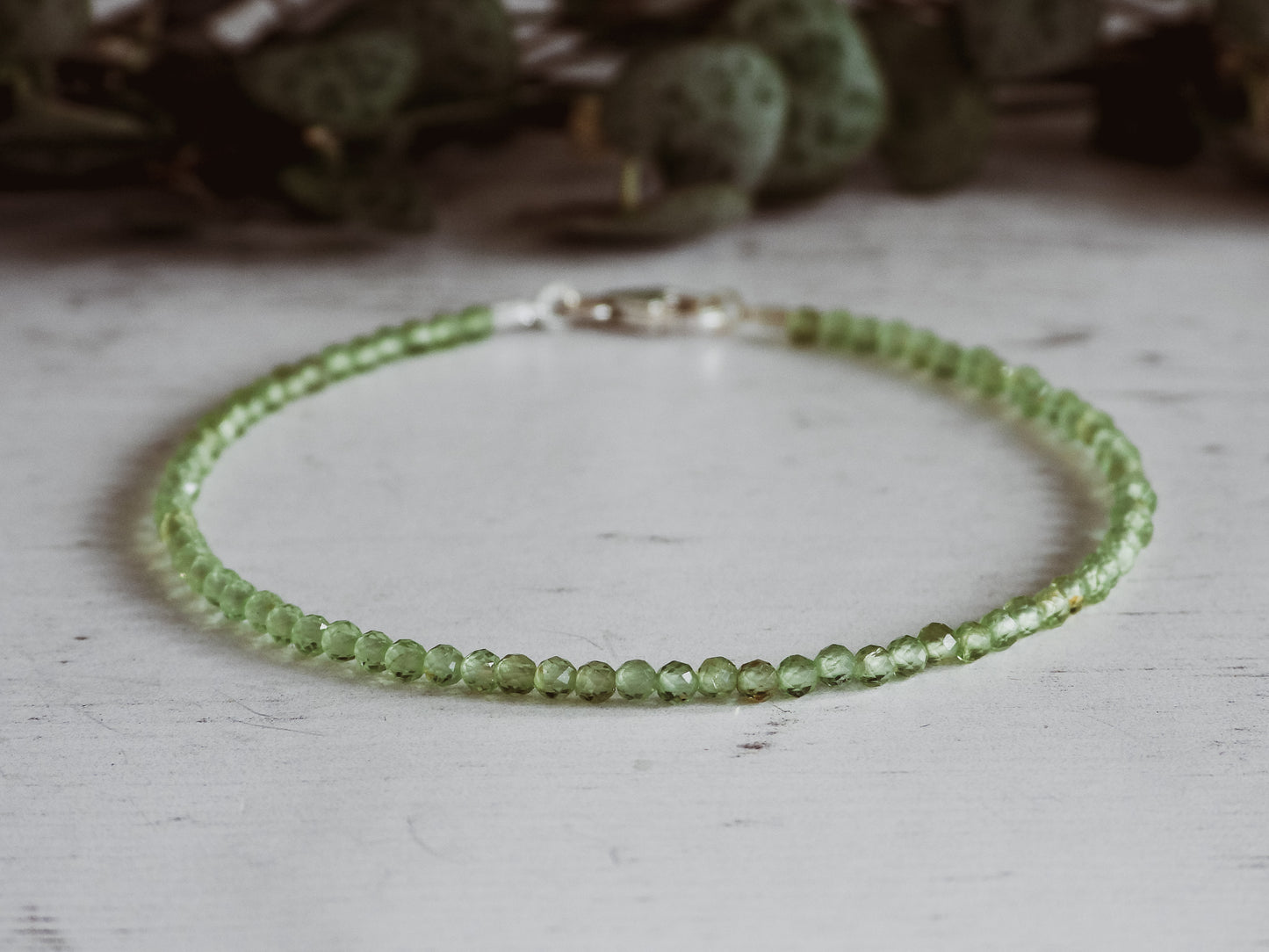 2mm peridot beaded bracelet with faceted beads