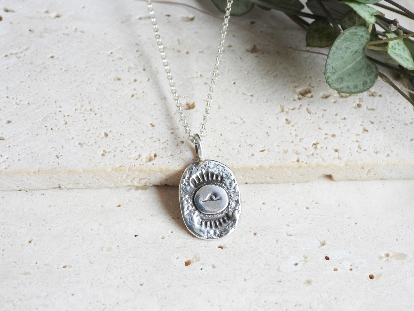 rustic and textured silver charm necklace with wave in bohemian style