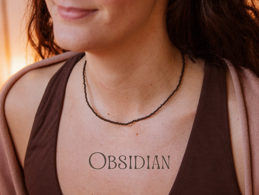 Person wearing an obsidian necklace with the gemstone name 'Obsidian' displayed.