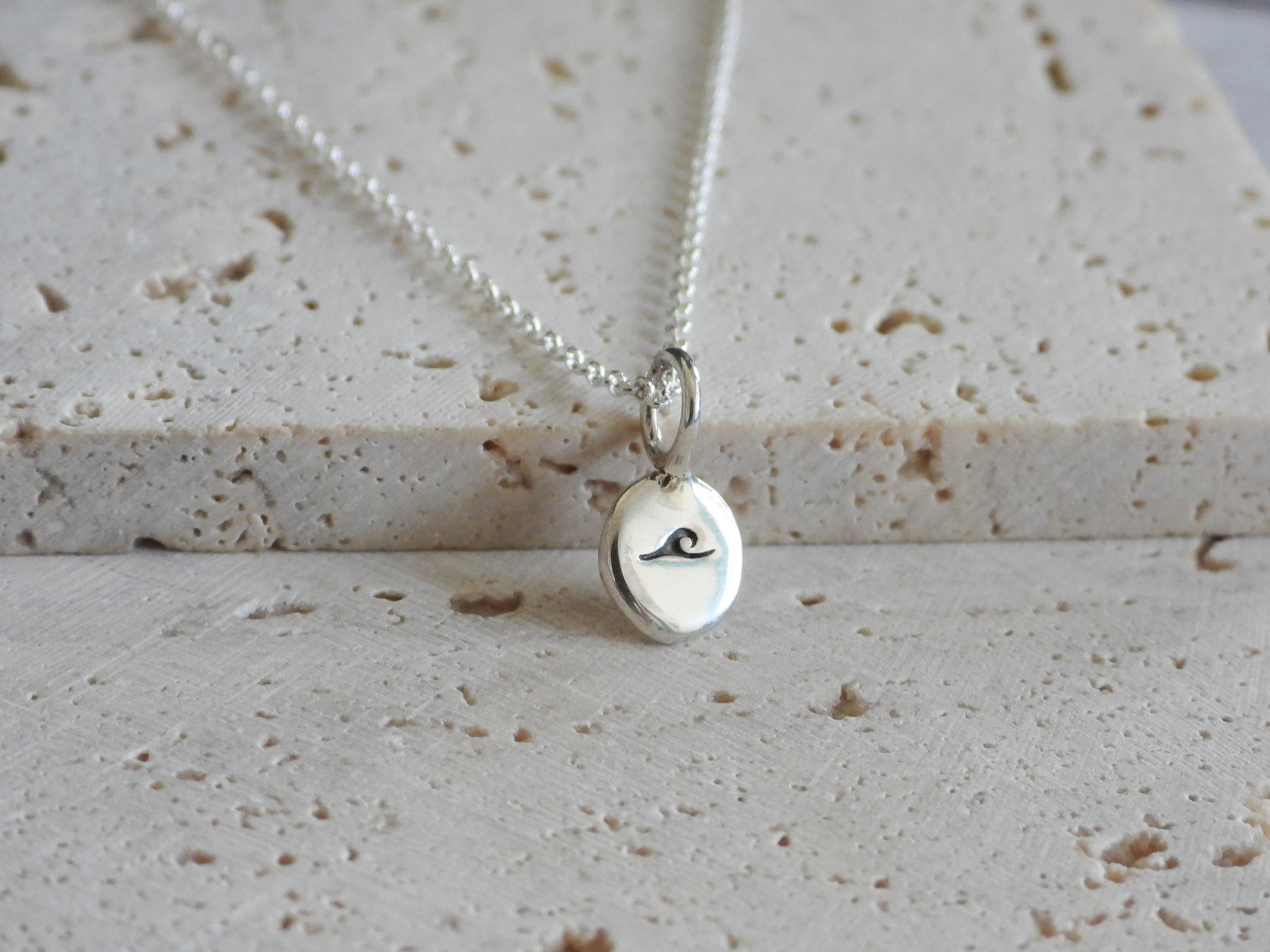 dainty surf girl necklace with wave in sterling silver