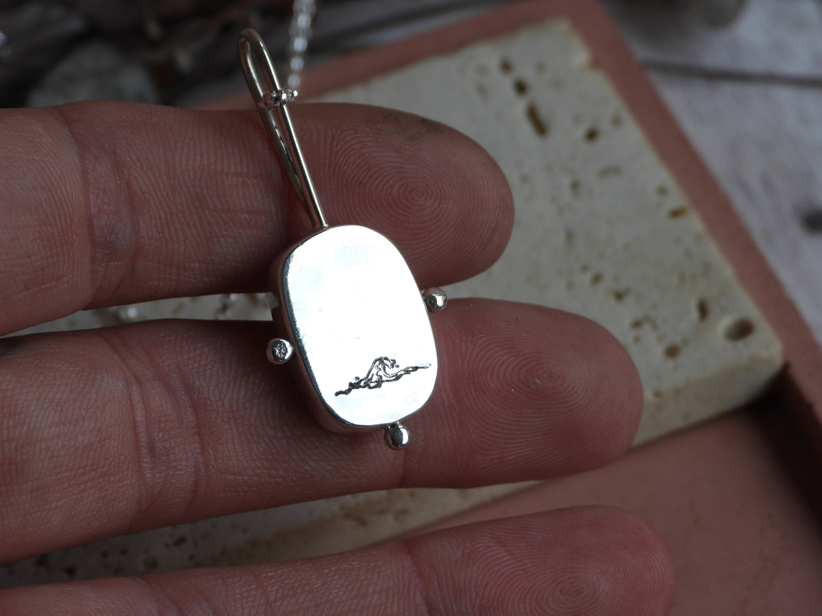 boulder opal necklace with hidden wave engraving for ocean lovers 