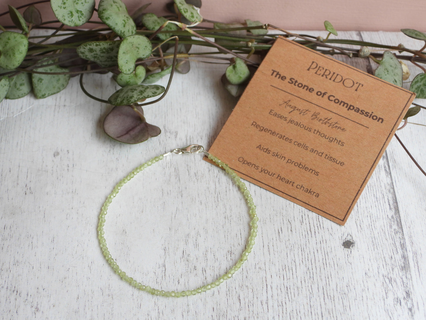 peridot gemstone crystal healing bracelet with properties card