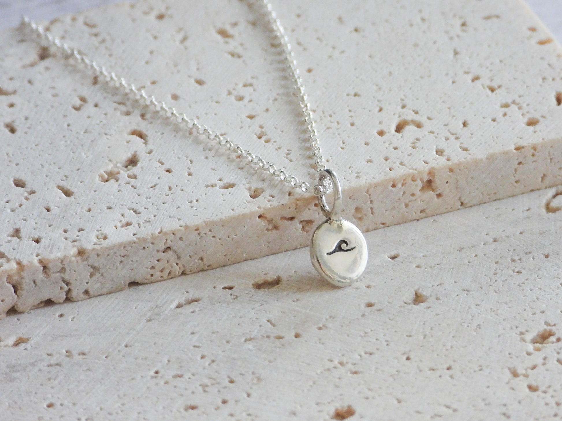 Ula jewellery charm necklace with wave symbol